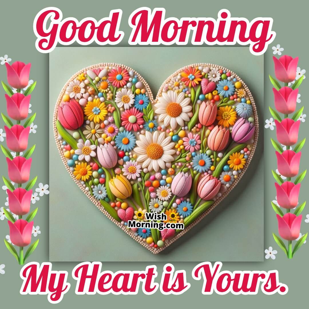 A heart-shaped ornament made from vibrant flowers, with morning light creating a soft, warm glow