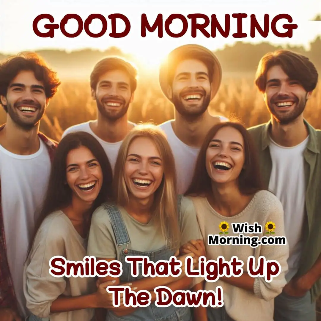 Group of friends standing together at dawn, smiling and laughing in a field as the early sun casts a warm, cheerful glow over them.
