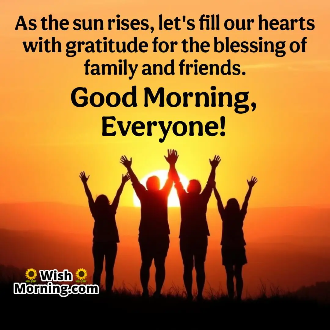 A group of family and friends standing together at sunrise, expressing gratitude for their bond.