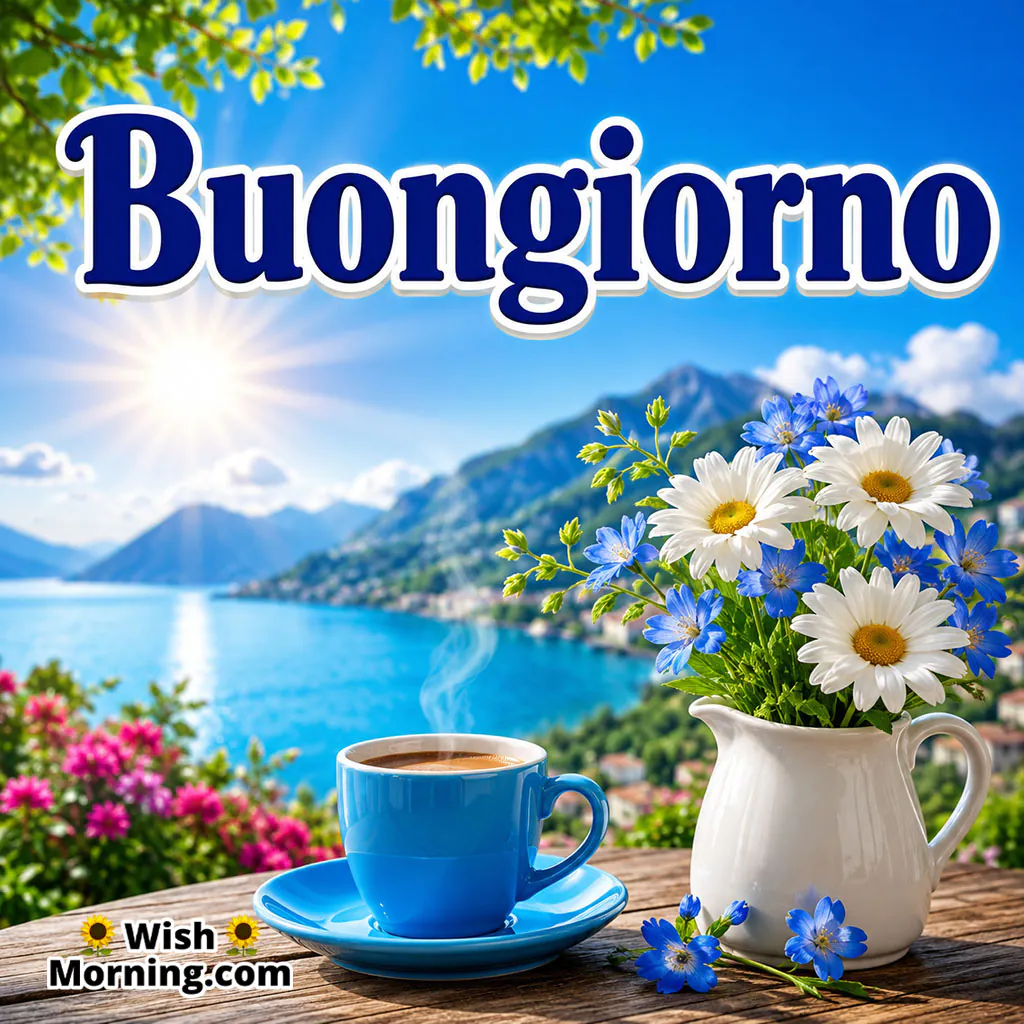 Buongiorno Morning Coffee Image featuring a blue coffee cup, fresh white and blue flowers, a scenic lake and sunlit mountains creating a peaceful morning setting.